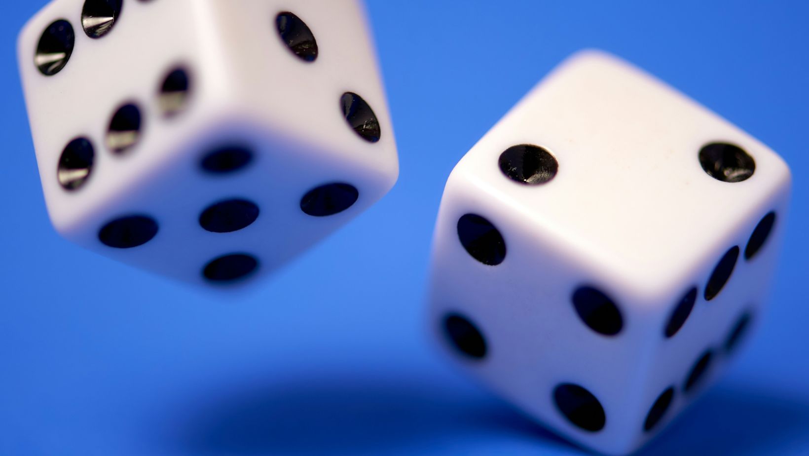 Two dice on a blue background.