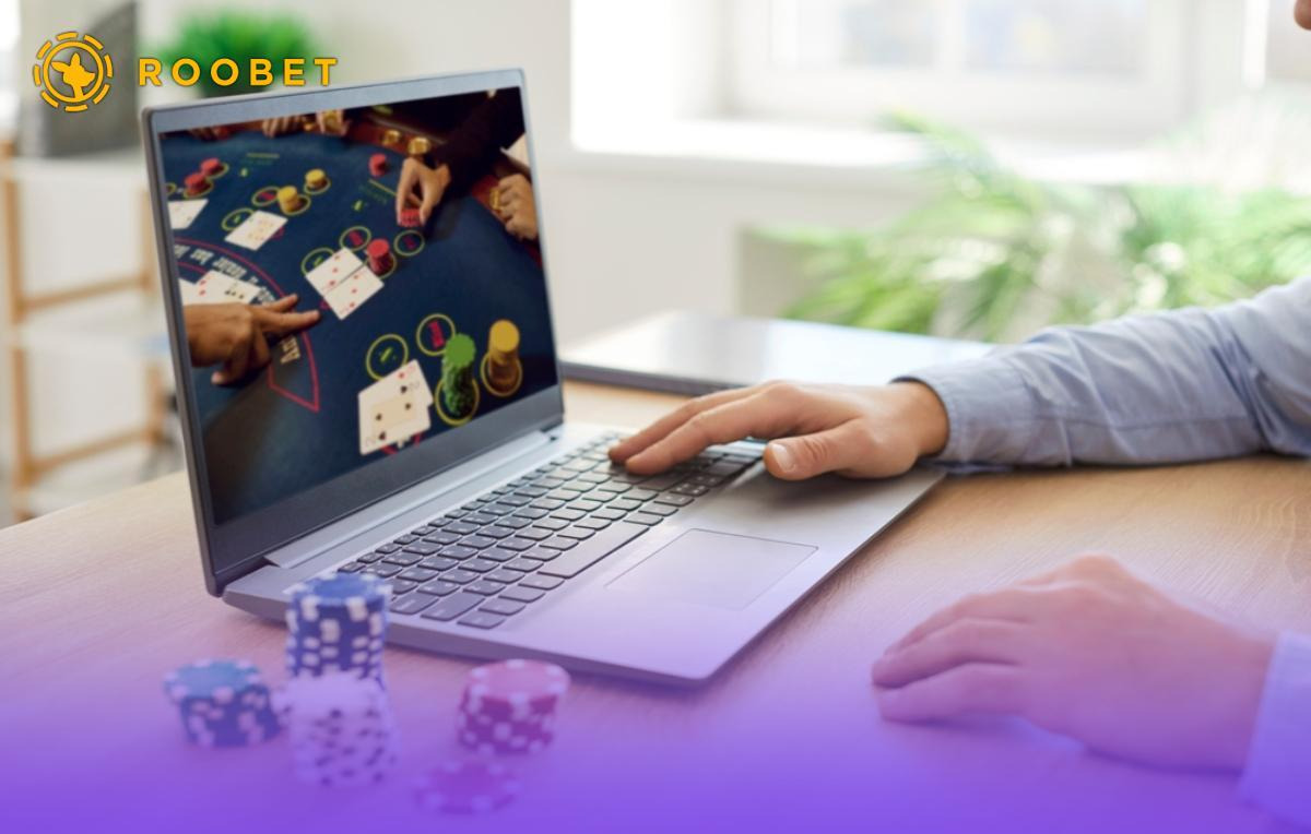 An image of a person playing games on a laptop